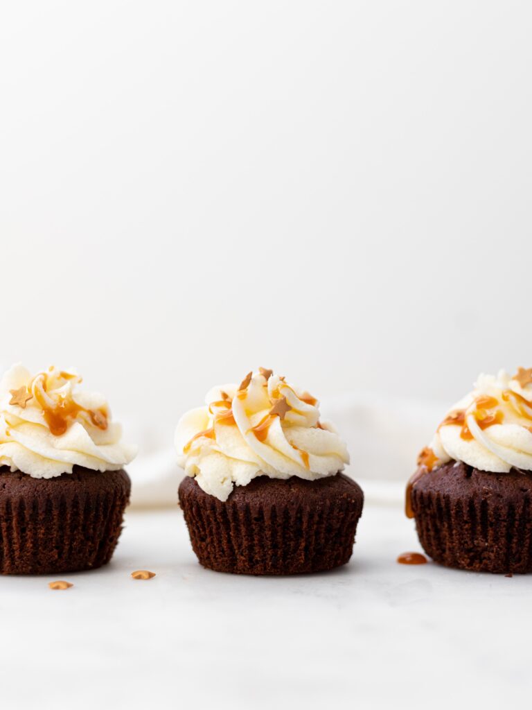 row of cupcakes with vanilla icing