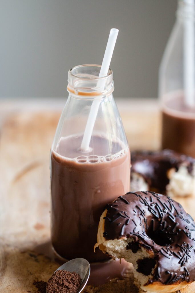 Close-up Of A Bottle Of Cocoa And A Doughnut
